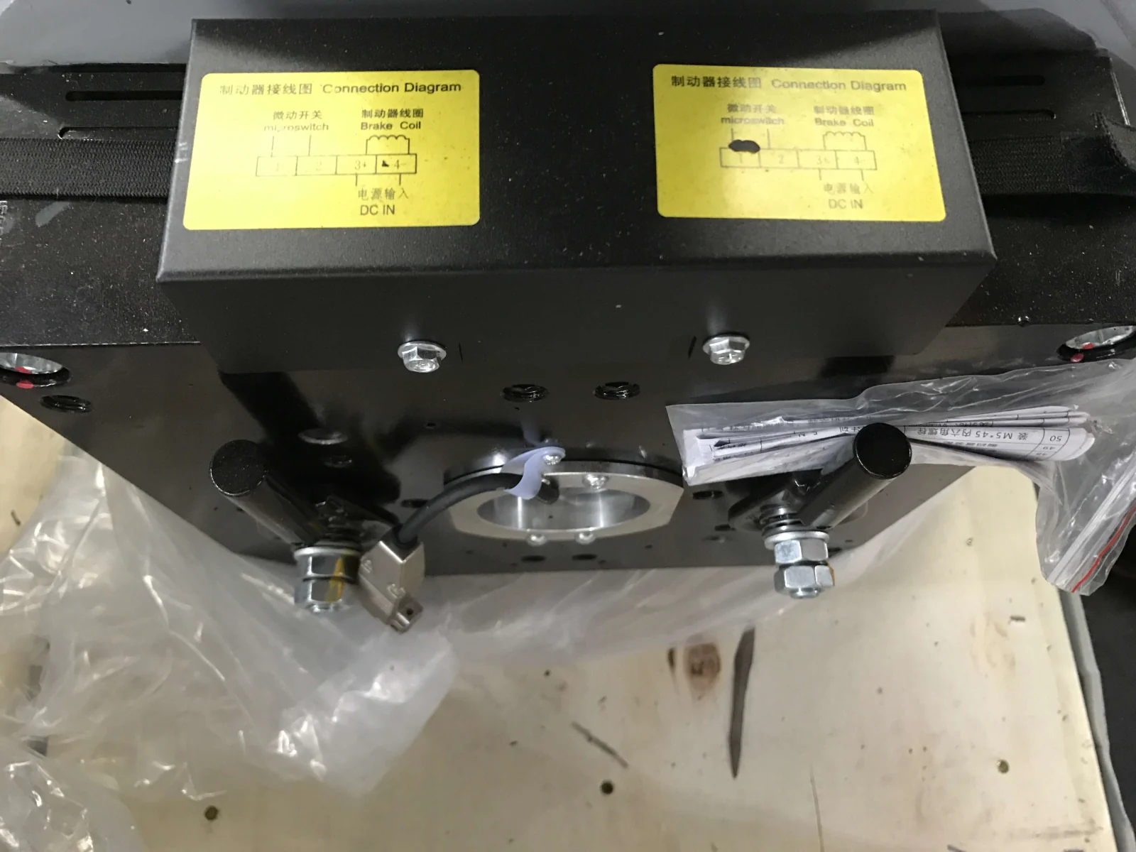 Close-up of a traction machine brake with two connection labels