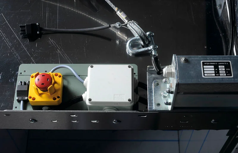 Stop switch and electrical enclosures on top of a compact lift car