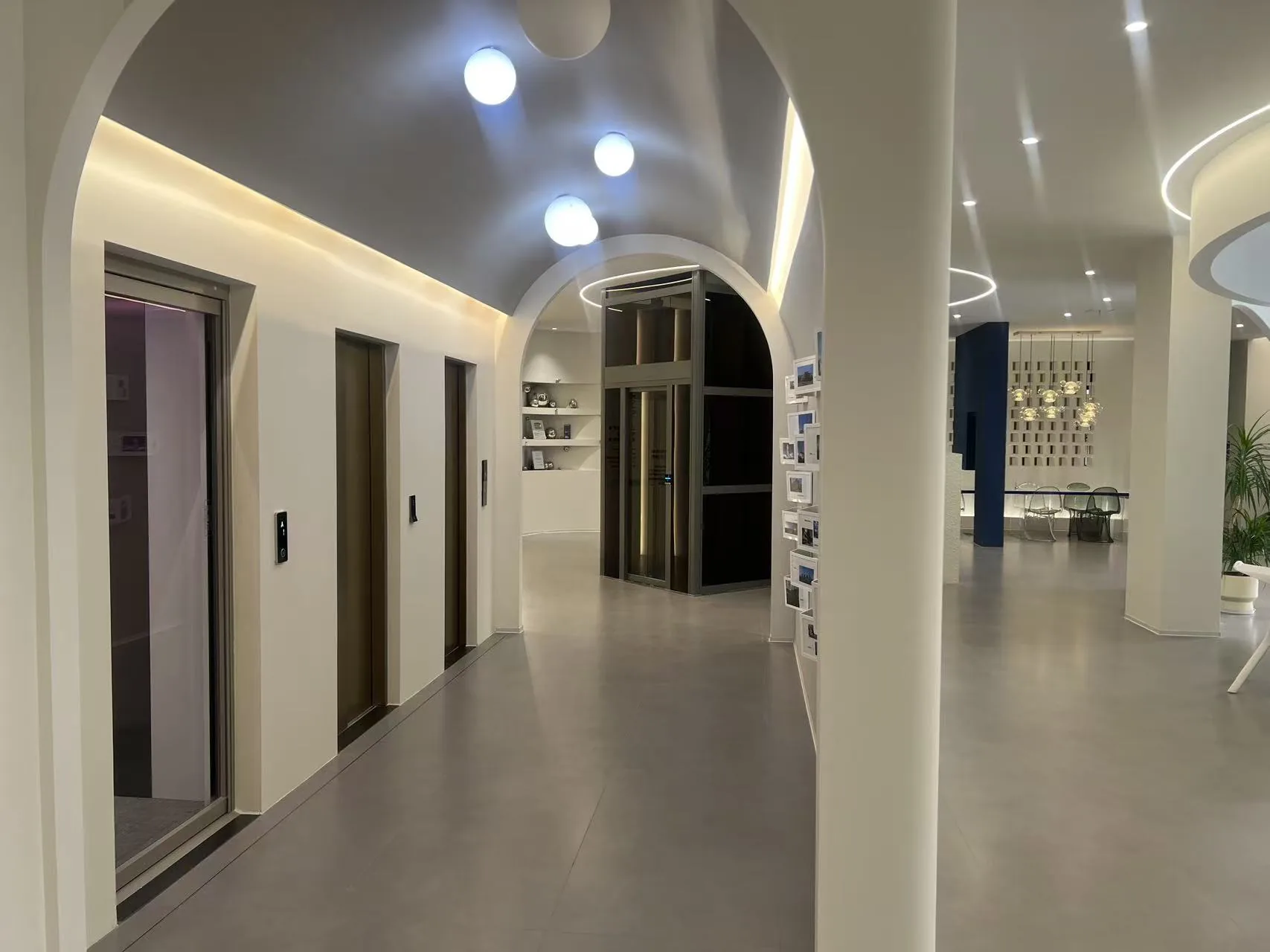 Showroom corridor lined with elevator cabin and entrance design displays